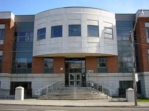 Rounded entrance colonnade of giant brick school