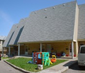 66 Walpole Three north-facing windowless roofs, each set back from the other. Children’s play sets sit on trapezoidal lawn area